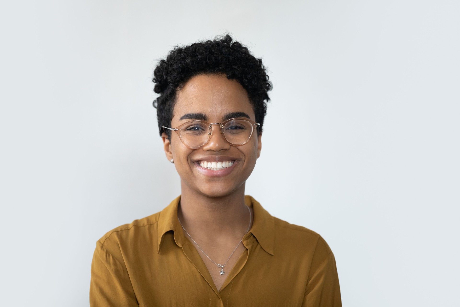 Happy millennial Afro American business woman posing isolated on white